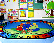 A soft circle time rug for group fun in one of our colorful classrooms